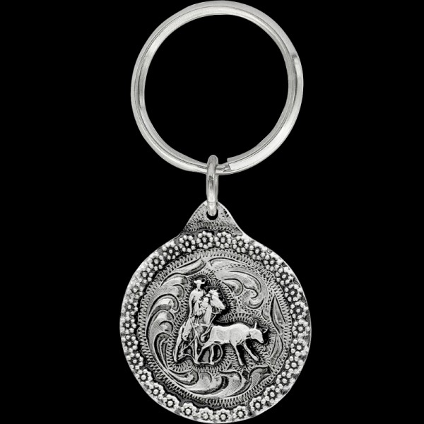 Heeler Keychain, Molly’s heeler  keychain is made with a detailed berry border, a 3D calf roping figure, and comes with a key ring attachment. Each silver keychai